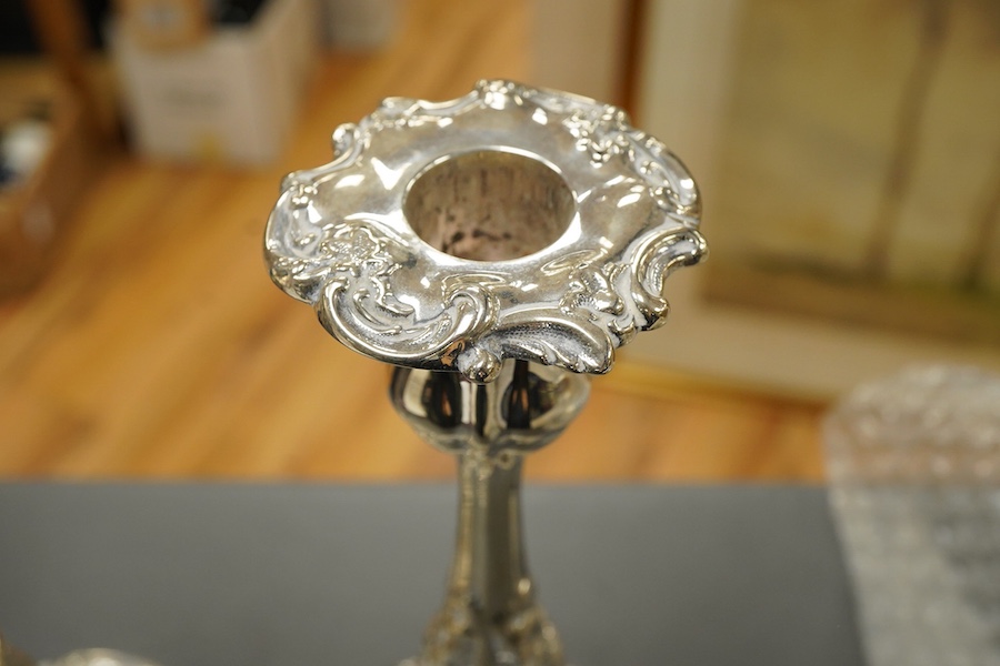 A pair of late Victorian silver candlesticks, with foliate decoration, by Walker & Hall, Sheffield, 1899, height 23cm, weighted.
